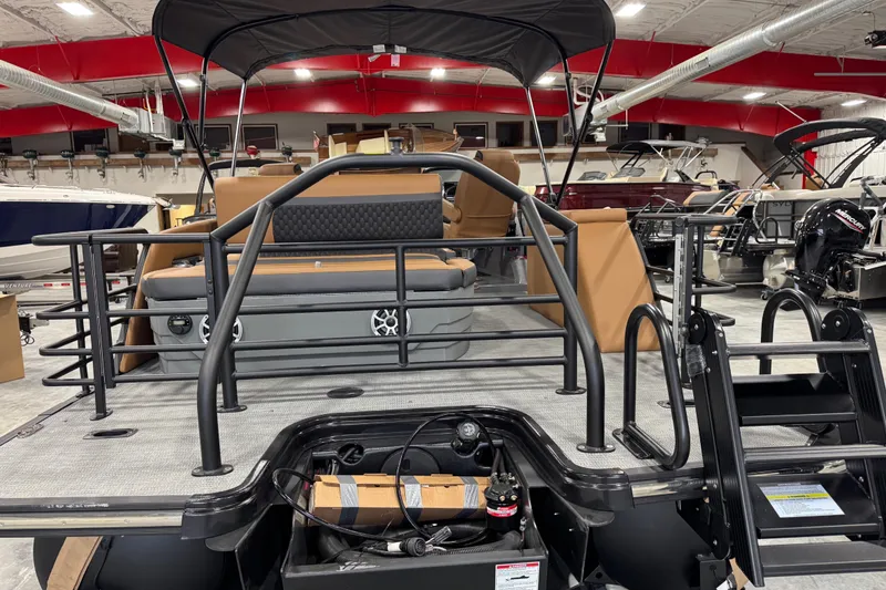 Slide: The Image of 2026 Sylvan L-5 pontoon boat interior with seating and railing in showroom. - 6