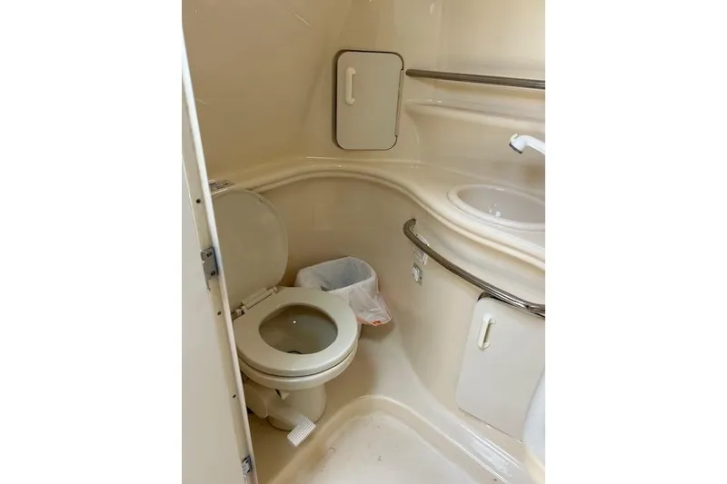 Slide: The Image of Bathroom interior of 2001 Sea Ray 340 Sundancer yacht, featuring toilet and sink. - 15