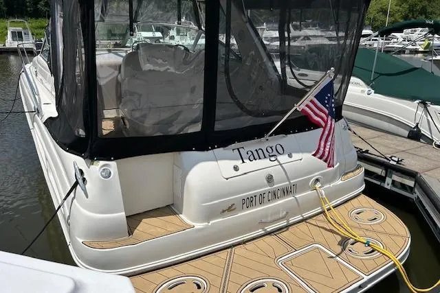 Slide: The Image of 2001 Sea Ray 340 Sundancer docked, displaying American flag and "Tango" name. - 23