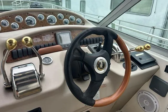 Slide: The Image of Helm of 2001 Sea Ray 340 Sundancer with steering wheel and control panel. - 5