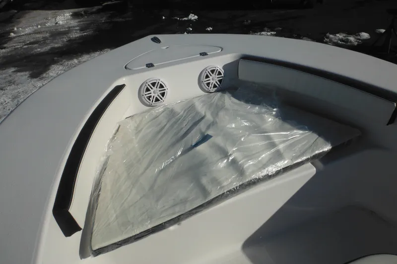 Slide: The Image of 2026 Tidewater 180 CC Adventure boat interior with cushioned seating and speakers. - 13