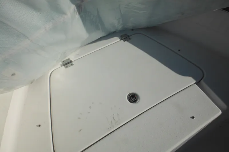 Slide: The Image of Hatch cover on 2026 Tidewater 180 CC Adventure boat, partially covered by tarp. - 17