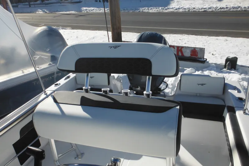 Slide: The Image of 2026 Tidewater 180 CC Adventure boat interior with seating and helm, snowy background. - 23