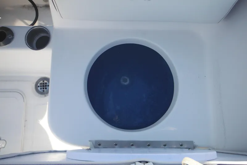 Slide: The Image of Livewell on 2026 Tidewater 180 CC Adventure boat, featuring a circular blue interior. - 27