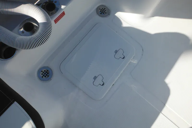 Slide: The Image of 2026 Tidewater 180 CC Adventure boat deck with storage hatch and drainage system. - 29