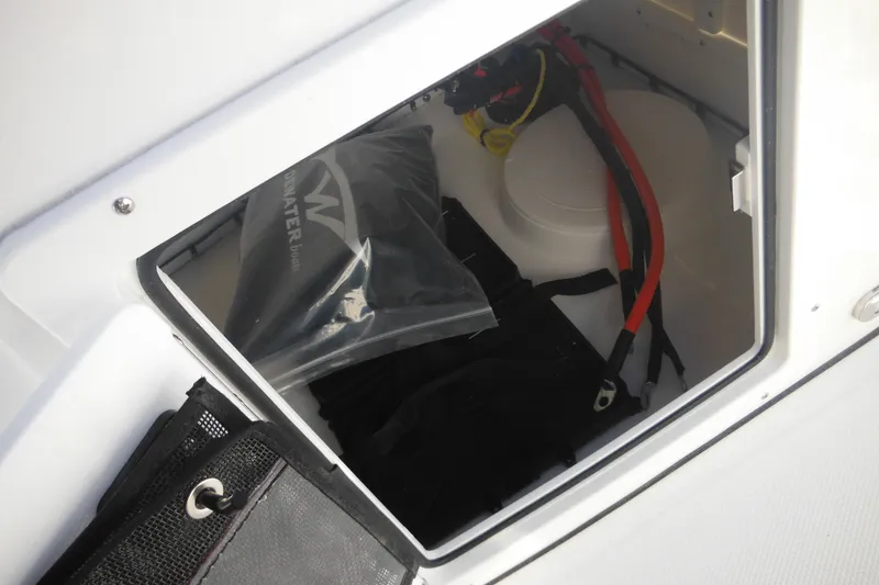 Slide: The Image of Storage compartment of 2026 Tidewater 180 CC Adventure boat with cables and equipment. - 34