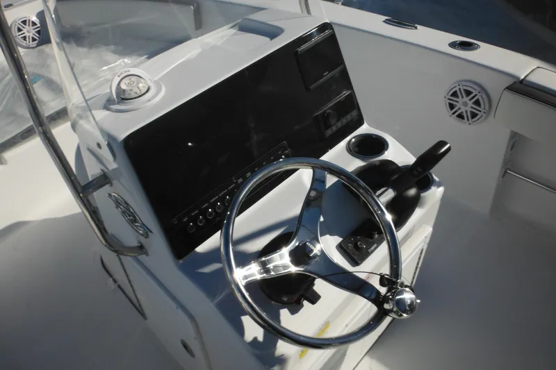Slide: The Image of 2026 Tidewater 180 CC Adventure boat console with steering wheel and controls. - 35
