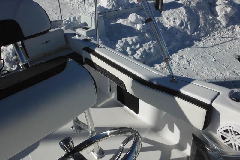 Slide: The Image of 2026 Tidewater 180 CC Adventure boat interior with steering wheel and seating. - 38