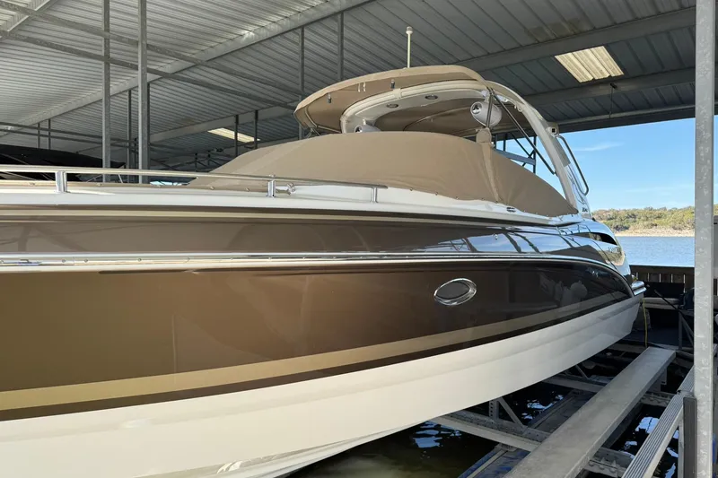 Slide: The Image of 2018 Formula 310 Bowrider boat docked under a covered marina. - 1