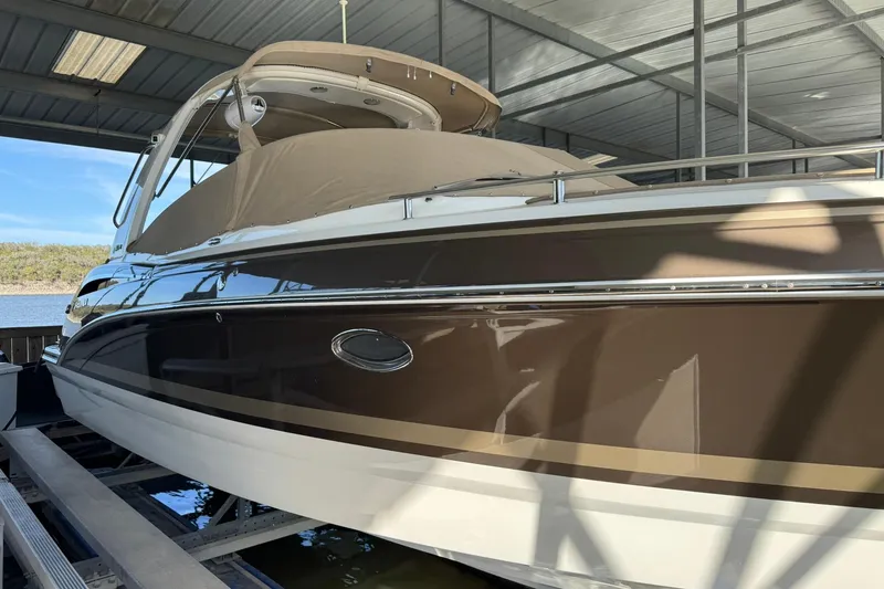 Slide: The Image of 2018 Formula 310 Bowrider boat in covered dock, side view. - 10