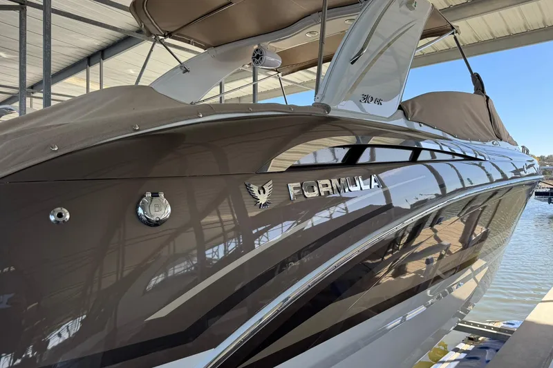 Slide: The Image of 2018 Formula 310 Bowrider boat docked under a covered marina. - 11