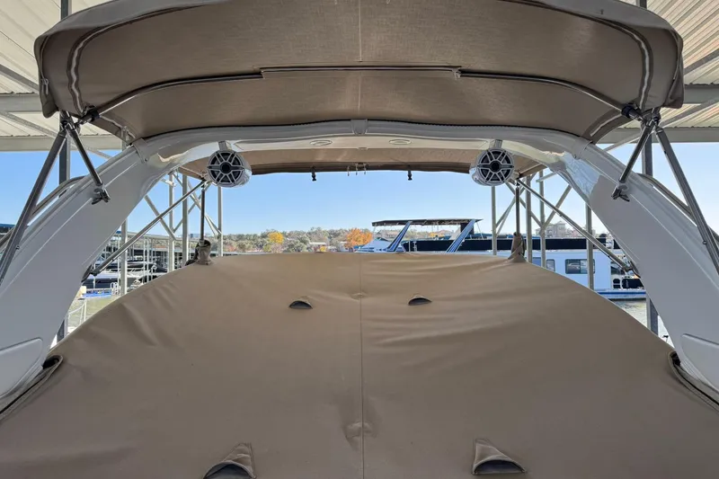 Slide: The Image of 2018 Formula 310 Bowrider with covered seating area and speakers, docked at marina. - 12