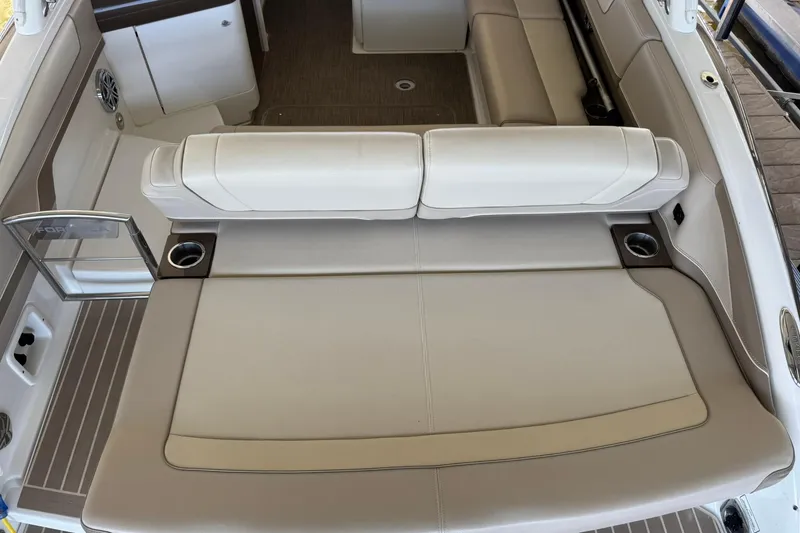 Slide: The Image of 2018 Formula 310 Bowrider interior with beige seating and cup holders. - 13