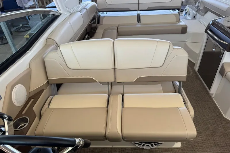 Slide: The Image of Luxurious seating in 2018 Formula 310 Bowrider boat, featuring beige upholstery and modern design. - 17