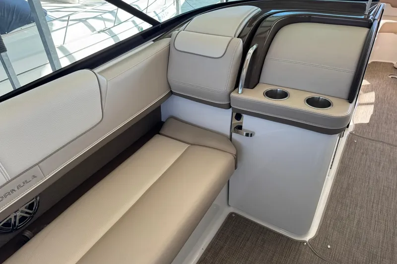 Slide: The Image of 2018 Formula 310 Bowrider interior with beige seating and cup holders. - 19
