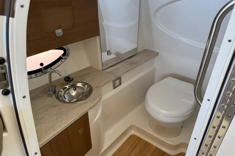 Slide: The Image of 2018 Formula 310 Bowrider bathroom with sink, toilet, and wooden accents. - 20