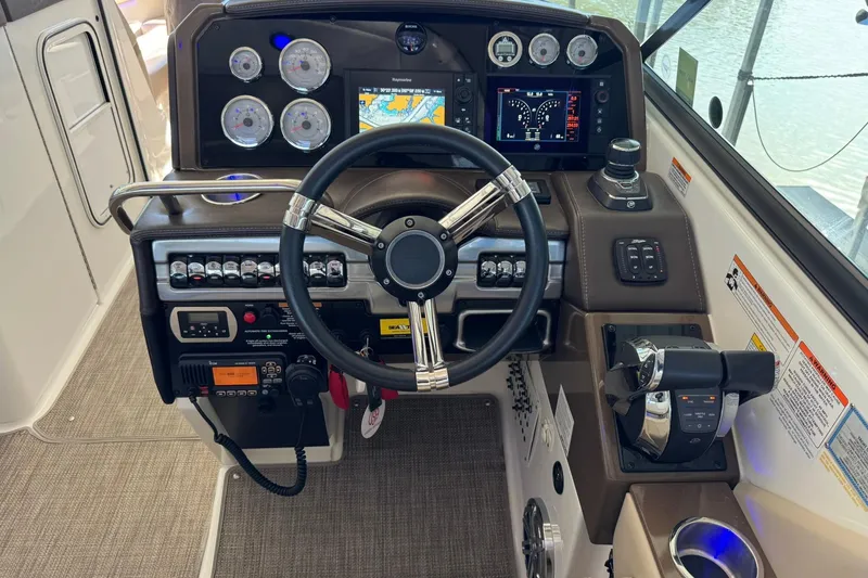 Slide: The Image of 2018 Formula 310 Bowrider dashboard with steering wheel, gauges, and navigation system. - 22