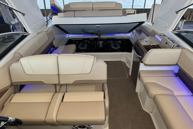 Slide: The Image of 2018 Formula 310 Bowrider interior with beige seating and open engine compartment. - 26