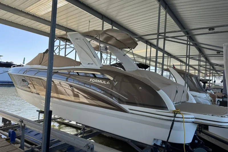Slide: The Image of 2018 Formula 310 Bowrider boat docked in a covered marina. - 3