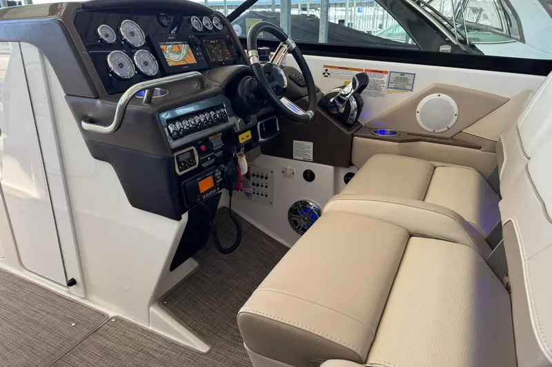 Slide: The Image of 2018 Formula 310 Bowrider cockpit with modern controls and beige seating. - 42