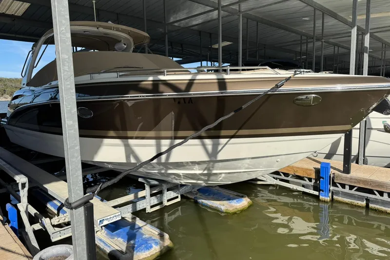Slide: The Image of 2018 Formula 310 Bowrider boat docked in a covered marina. - 9