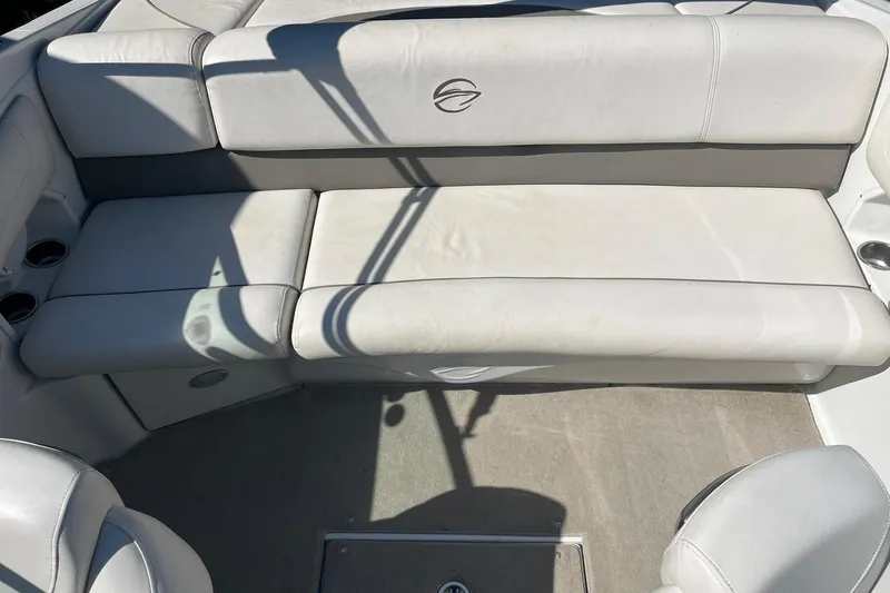 Slide: The Image of 2010 Crownline 210 LS boat interior with white leather seating and cup holders. - 11