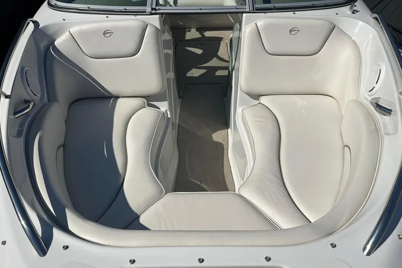 Slide: The Image of 2010 Crownline 210 LS boat interior with white cushioned seating. - 12
