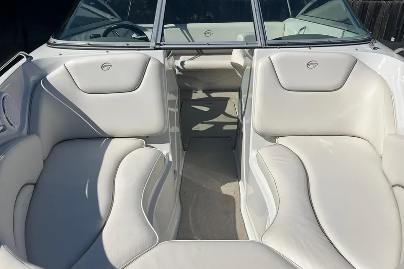 Slide: The Image of 2010 Crownline 210 LS boat interior with white leather seating and steering wheel. - 13