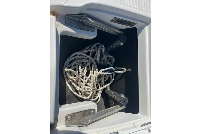 Slide: The Image of 2010 Crownline 210 LS boat anchor storage with rope inside. - 2
