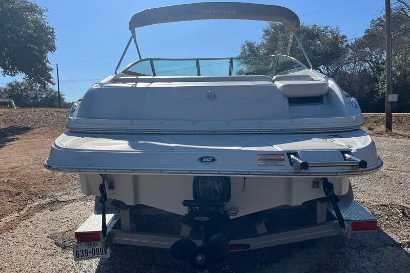 Slide: The Image of 2010 Crownline 210 LS boat rear view with trailer in outdoor setting. - 4