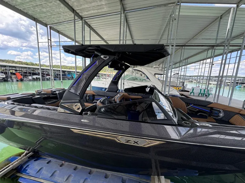 Slide: The Image of 2025 Tigé Ultré 25ZX boat docked, featuring sleek design. - 5