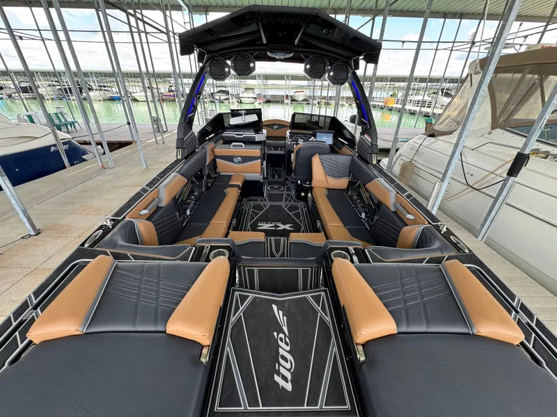Slide: The Image of Interior view of 2025 Tigé Ultré 25ZX boat docked in marina. - 9