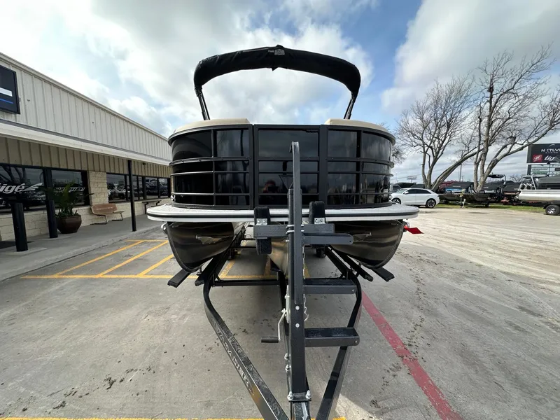 Slide: The Image of Trifecta 22 UL CS 2026 pontoon boat on trailer outside store. - 8