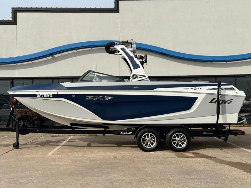 The Image of 2023 Tigé 23ZX boat on trailer, side view. - 1