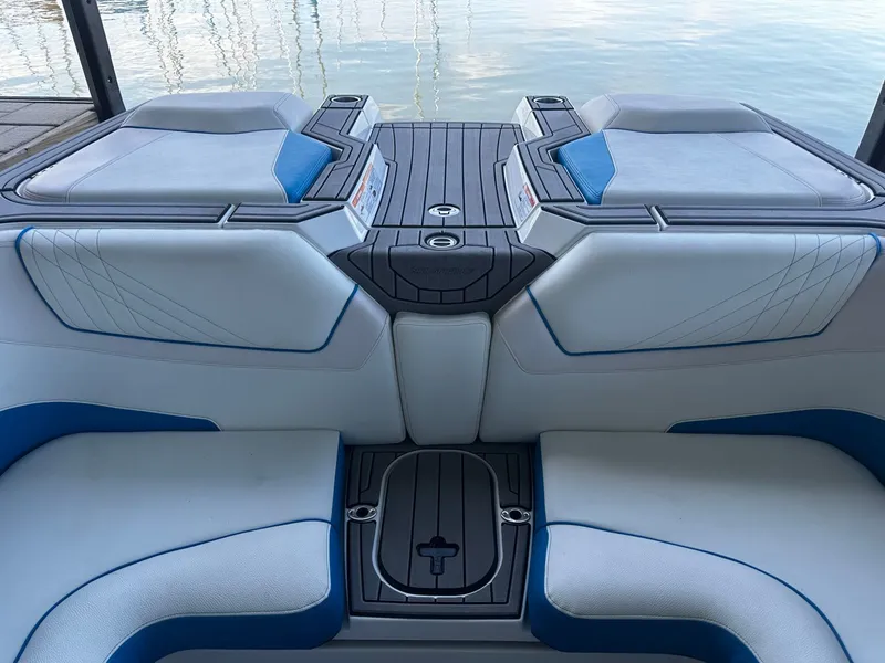 Slide: The Image of Interior of a 2021 Nautique GS24 boat with blue and white seating. - 11