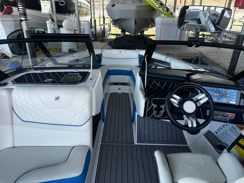 Slide: The Image of Interior of a 2021 Nautique GS24 boat with modern dashboard. - 14
