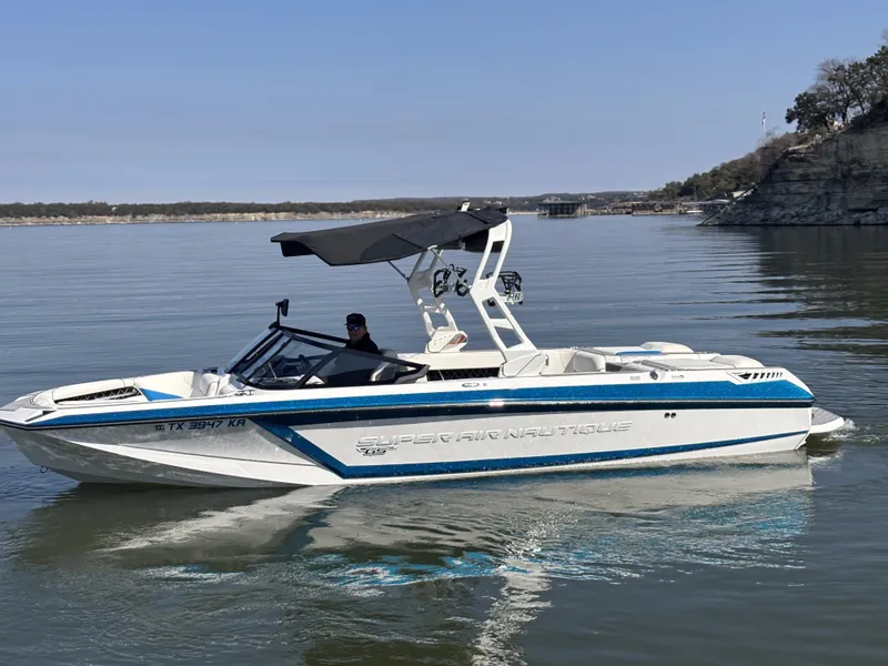 Slide: The Image of 2021 Nautique GS24 boat on calm water. - 4