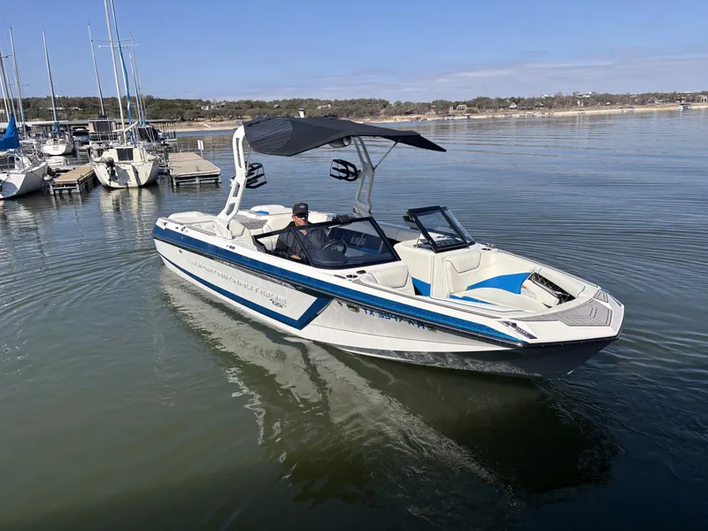 Slide: The Image of 2021 Nautique GS24 boat on calm water. - 6