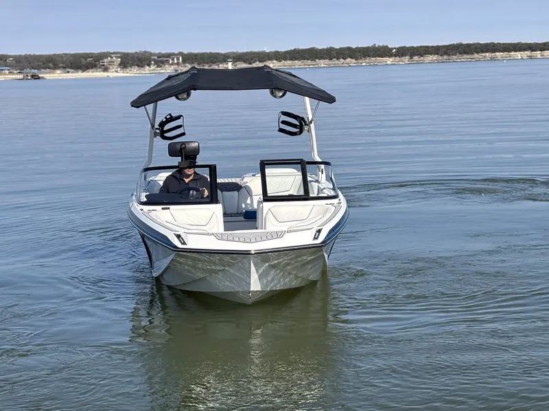 Slide: The Image of 2021 Nautique GS24 boat on calm water. - 7