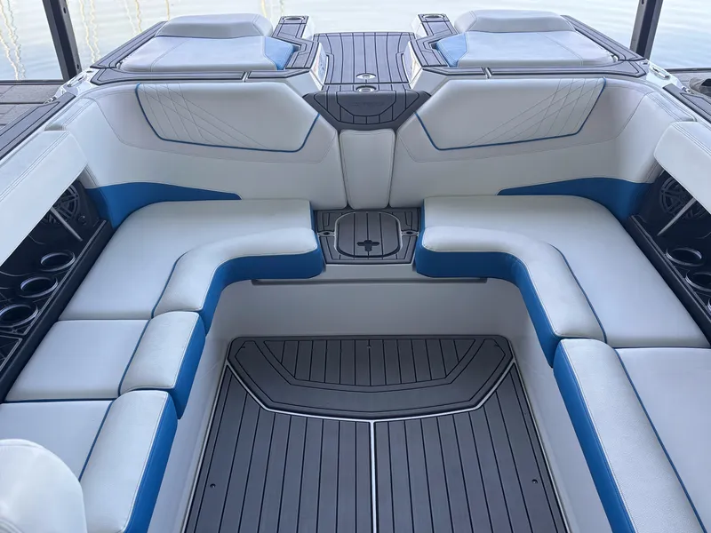 Slide: The Image of Interior of a 2021 Nautique GS24 boat with blue and white seating. - 8
