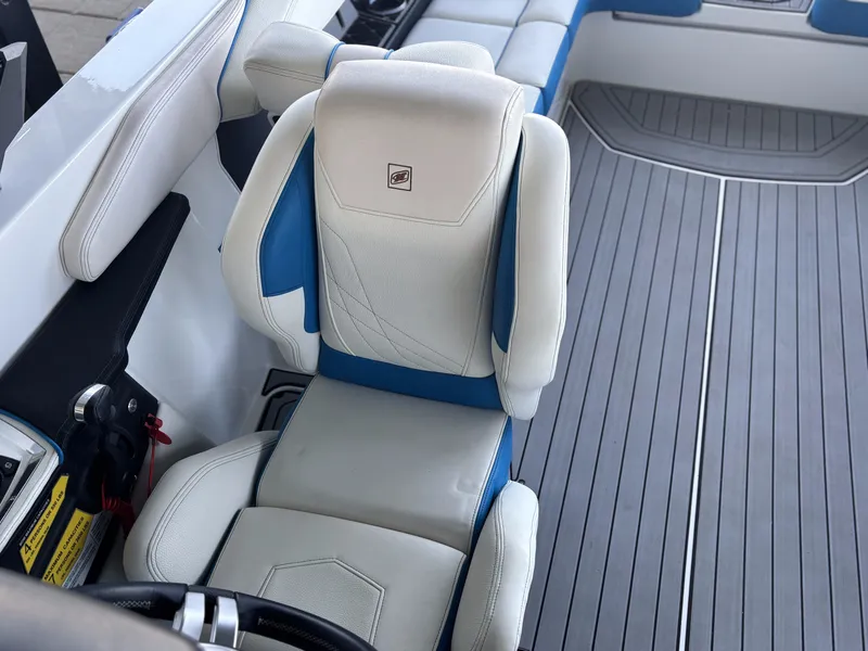 Slide: The Image of Interior of a 2021 Nautique GS24 boat with white and blue seating. - 9