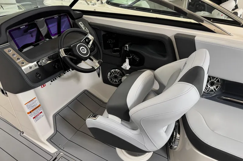 Slide: The Image of 2026 Chaparral 270 OSX boat cockpit with modern steering and dual displays. - 19