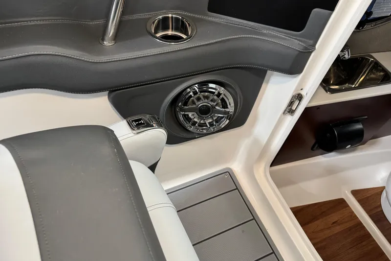 Slide: The Image of Interior of 2026 Chaparral 270 OSX boat featuring speaker and cup holder. - 22