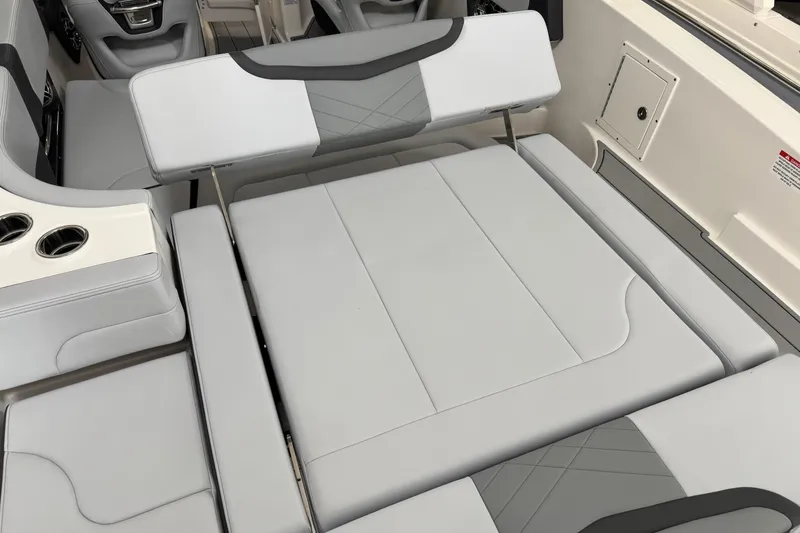 Slide: The Image of 2026 Chaparral 270 OSX boat interior with convertible seating and cup holders. - 25