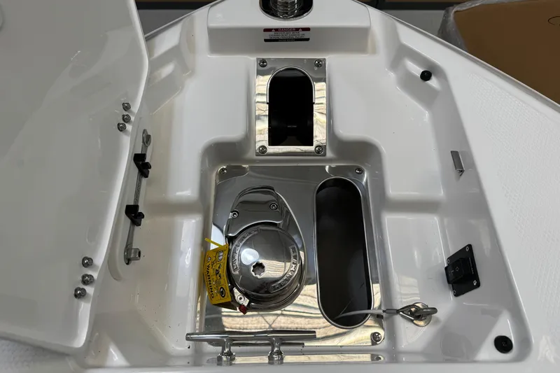 Slide: The Image of 2026 Chaparral 270 OSX boat anchor compartment with open hatch and winch system. - 29