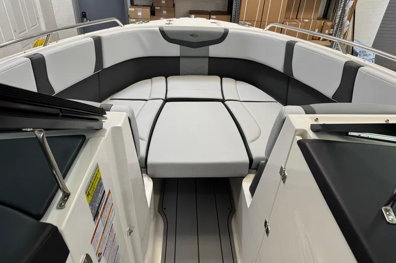 Slide: The Image of 2026 Chaparral 270 OSX boat interior with sleek, modern seating and storage compartments. - 32