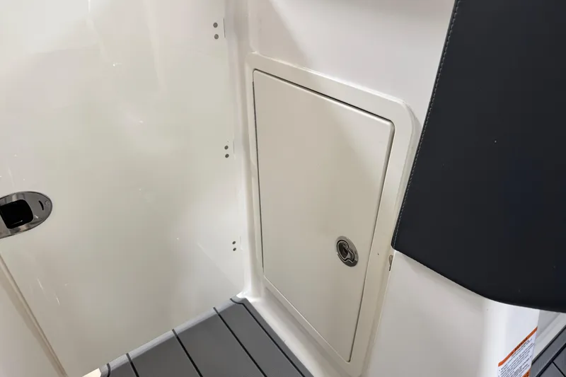 Slide: The Image of 2026 Chaparral 270 OSX boat interior storage compartment with sleek design. - 34