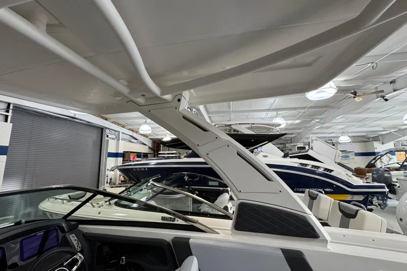 Slide: The Image of 2026 Chaparral 270 OSX boat interior in showroom, showcasing sleek design and modern features. - 43