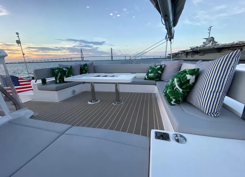 Slide: The Image of Leopard 50 Yacht 2020 with stylish deck and cushions, sunset in background. - 15