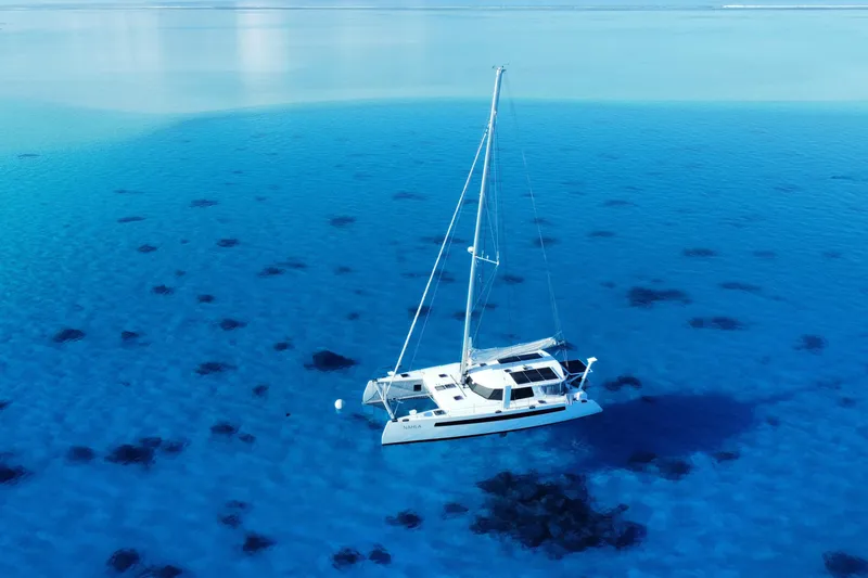 Slide: The Image of Sailboat Balance 526 (2022) on clear blue ocean waters. - 1